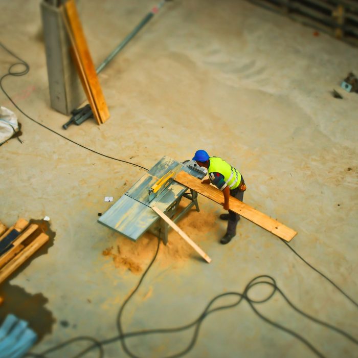 commercial builders - builder cutting wood